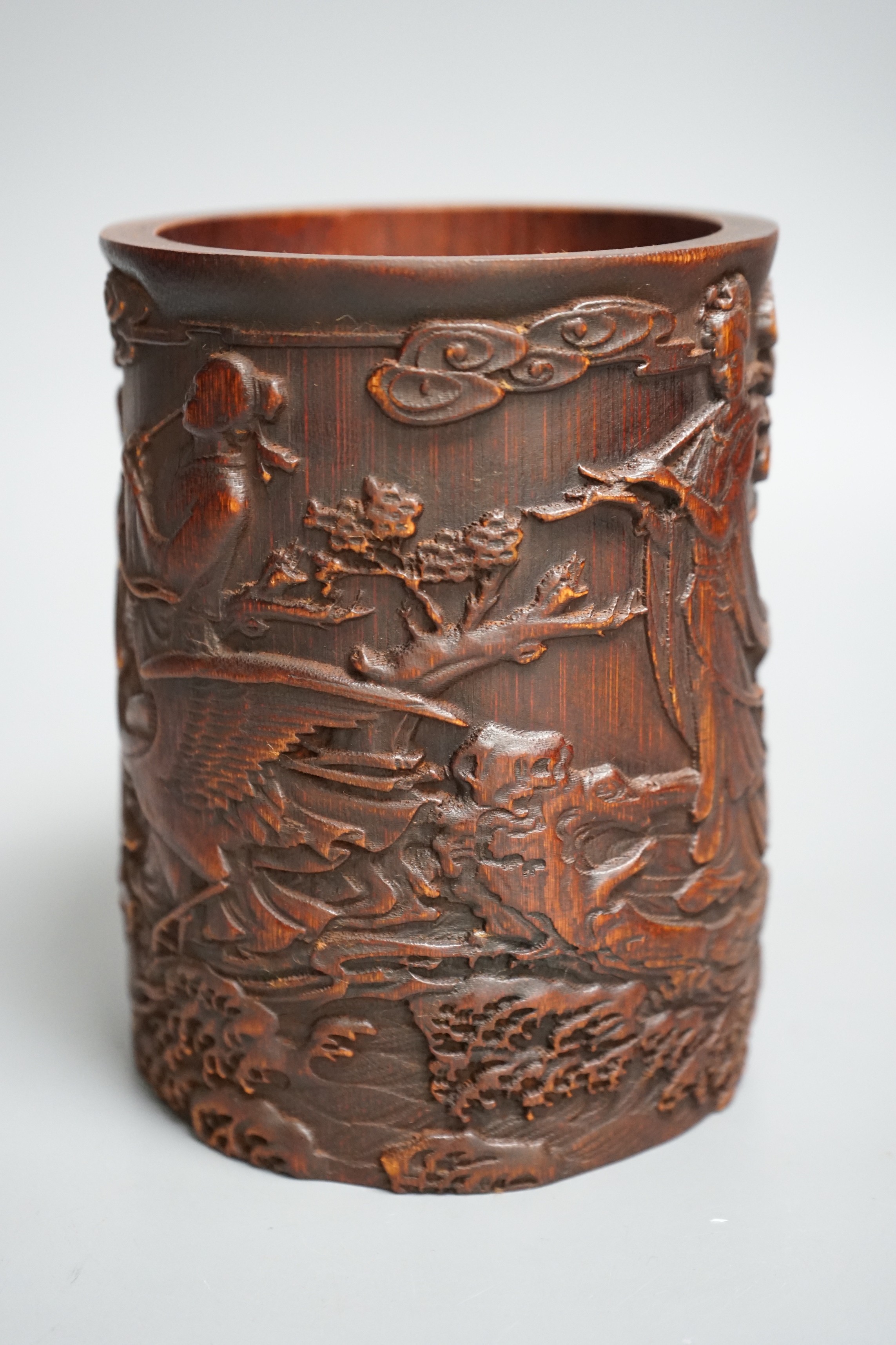 A Chinese 'immortals' carved bamboo brush pot, 16cm